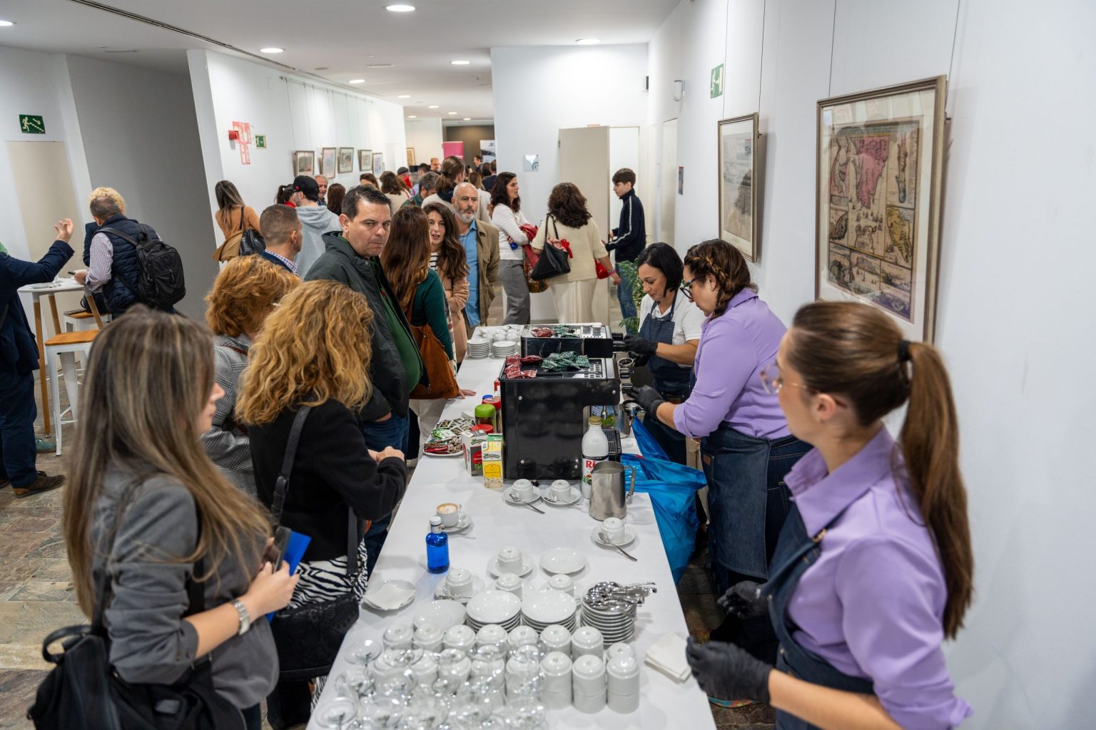 Zona de coffee break con asistentes en fila y personal sirviendo café durante la Feria Campo de Gibraltar en Digital 2024